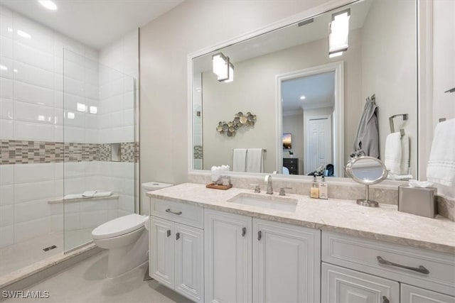 bathroom featuring vanity, toilet, and an enclosed shower