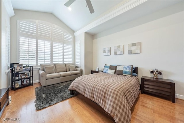 bedroom featuring ceiling fan, light hardwood / wood-style flooring, and lofted ceiling