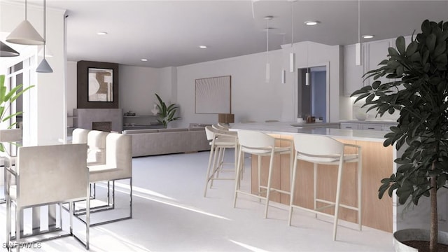 interior space with white cabinets, kitchen peninsula, and pendant lighting