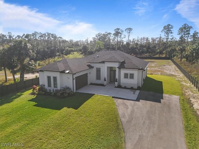 exterior space with a garage and a lawn