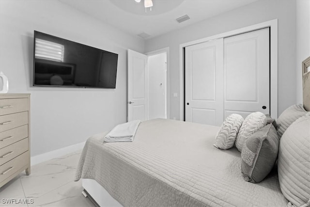 bedroom with ceiling fan and a closet