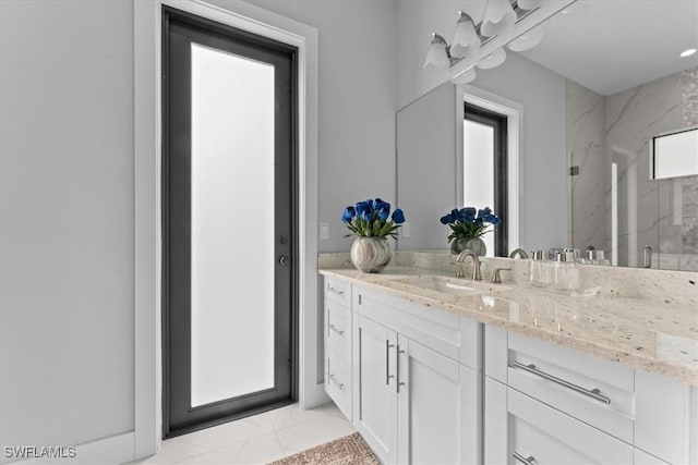 bathroom featuring vanity and a shower with shower door