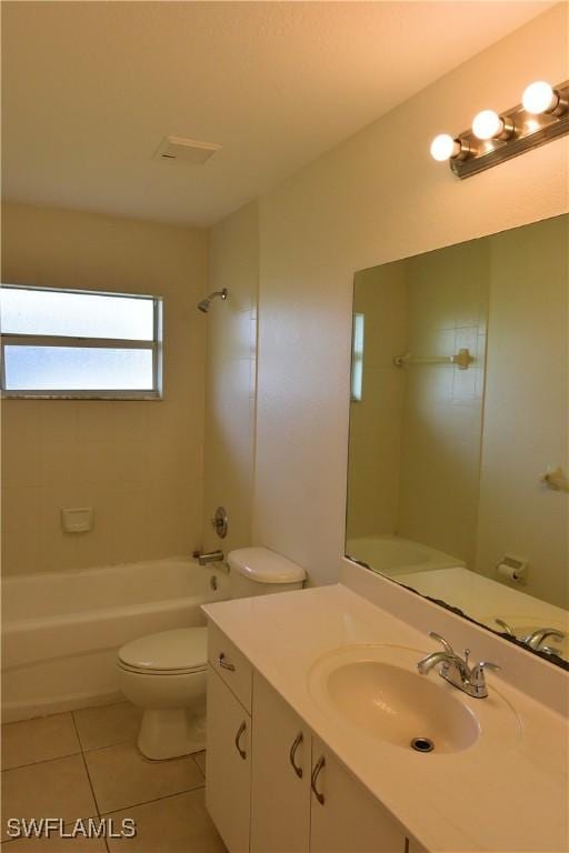 full bathroom featuring vanity, toilet, tiled shower / bath combo, and tile patterned flooring