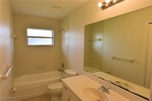 full bathroom featuring tiled shower / bath, vanity, toilet, and tile patterned flooring