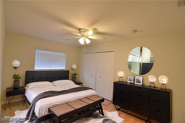 bedroom featuring ceiling fan, light hardwood / wood-style floors, and a closet