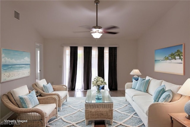 tiled living room featuring ceiling fan and lofted ceiling