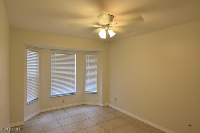 tiled empty room with ceiling fan