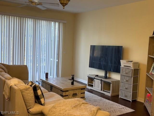 living room with dark hardwood / wood-style flooring