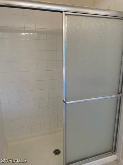 bathroom with a shower with door