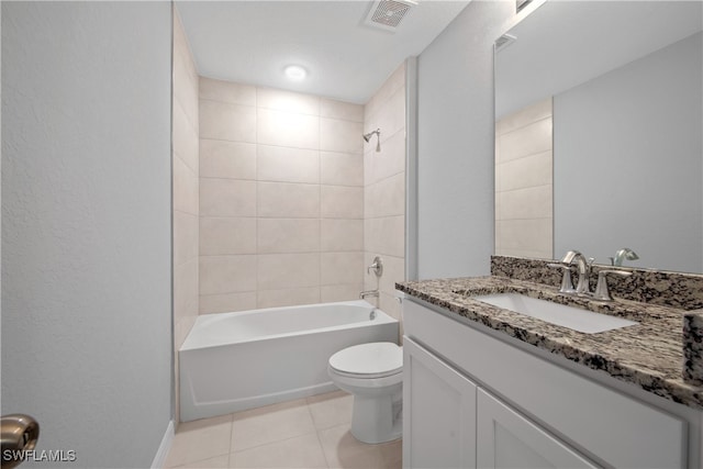 full bathroom with tile patterned floors, tiled shower / bath combo, vanity, and toilet