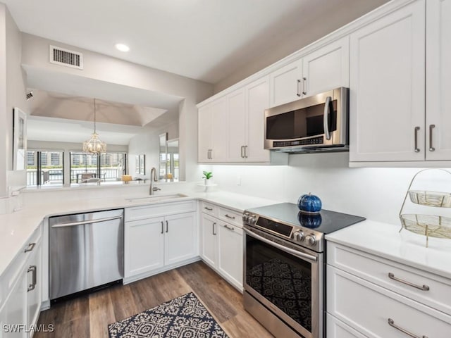 kitchen featuring white cabinetry, appliances with stainless steel finishes, dark hardwood / wood-style flooring, and sink