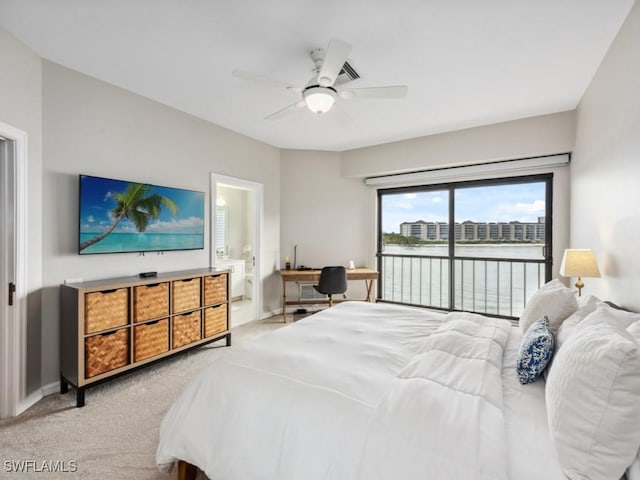 bedroom with ceiling fan, ensuite bath, and light colored carpet