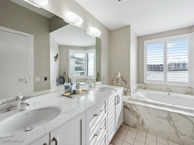 bathroom with vanity, tiled tub, a wealth of natural light, and tile patterned floors