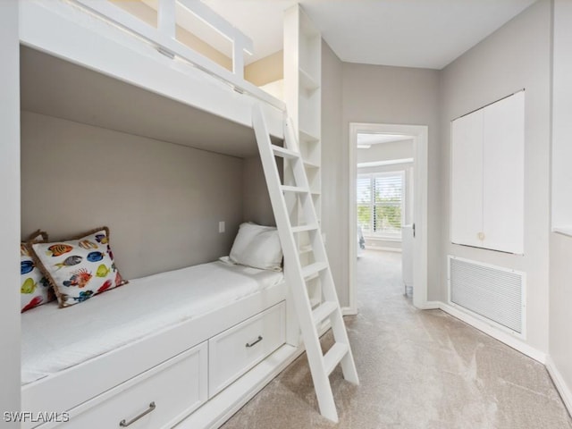 bedroom featuring light colored carpet