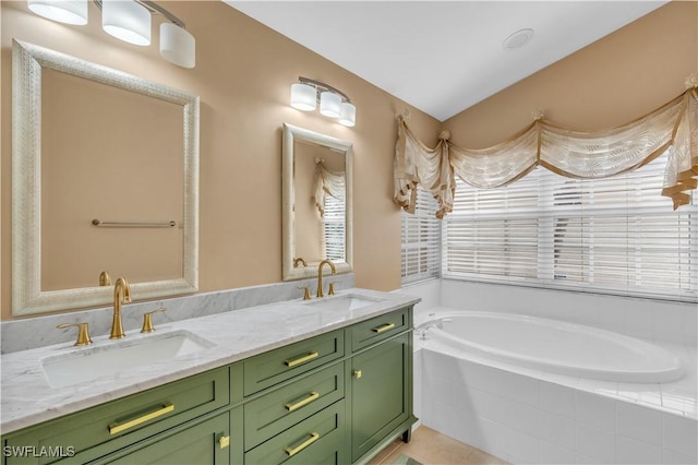 bathroom featuring tiled tub and vanity