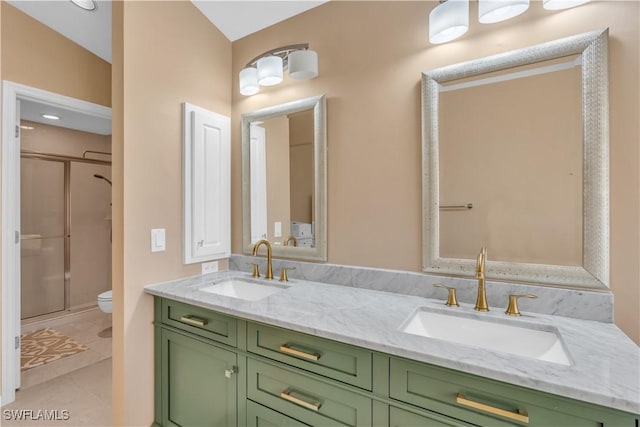 bathroom with toilet, tile patterned floors, walk in shower, vaulted ceiling, and vanity