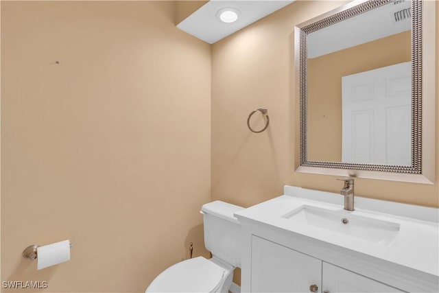 bathroom featuring toilet and vanity