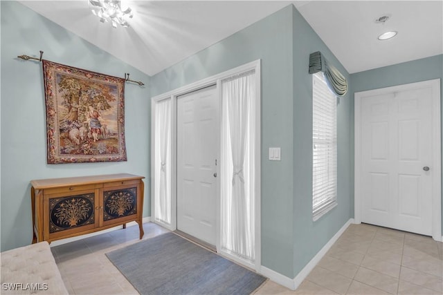 tiled foyer entrance with lofted ceiling