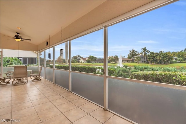 unfurnished sunroom featuring ceiling fan