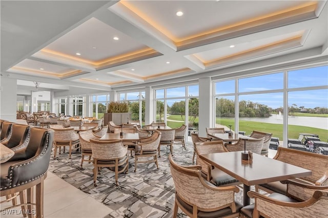 sunroom featuring plenty of natural light, beam ceiling, a water view, and coffered ceiling