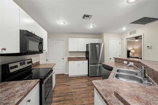 kitchen with ceiling fan, appliances with stainless steel finishes, sink, white cabinets, and dark wood-type flooring