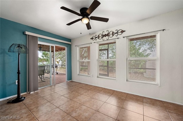 empty room featuring ceiling fan and light tile patterned floors