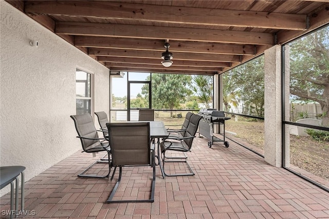 sunroom featuring beam ceiling and wood ceiling