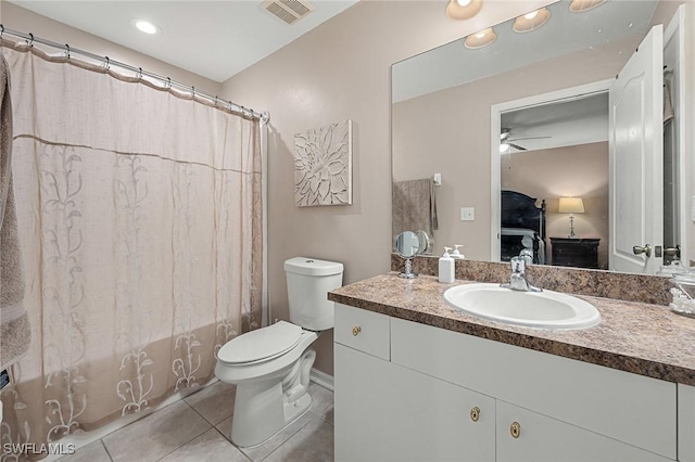 full bathroom with tile patterned flooring, vanity, shower / tub combo, toilet, and ceiling fan