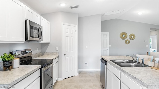 kitchen with sink, white cabinets, stainless steel appliances, and light tile patterned flooring