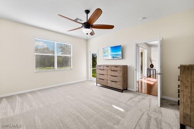 unfurnished bedroom featuring ceiling fan and light colored carpet