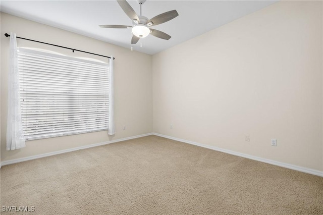 spare room featuring ceiling fan and carpet flooring