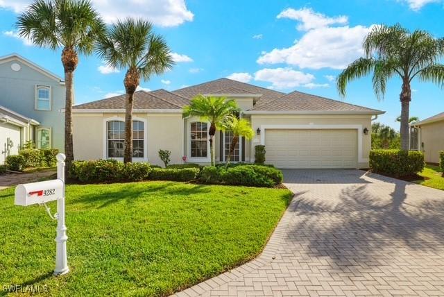 view of front of home featuring a garage and a front yard