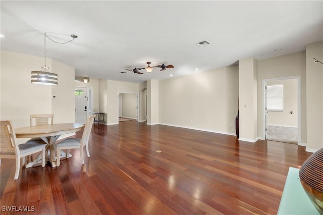 dining room with ceiling fan and dark hardwood / wood-style flooring