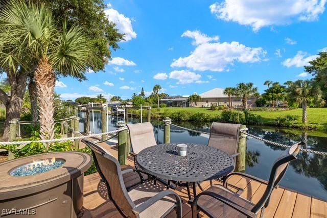 view of dock with a water view and an outdoor fire pit