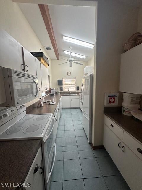 kitchen with white cabinetry, sink, and white appliances