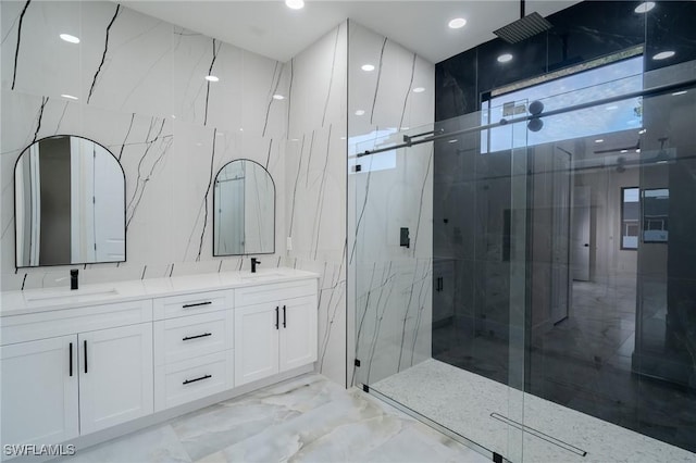 bathroom with vanity and a shower with door