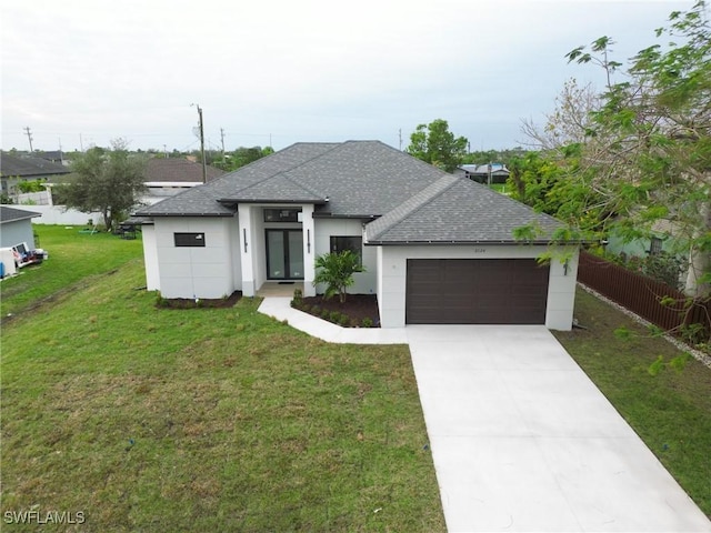 view of front of house featuring a garage and a front lawn