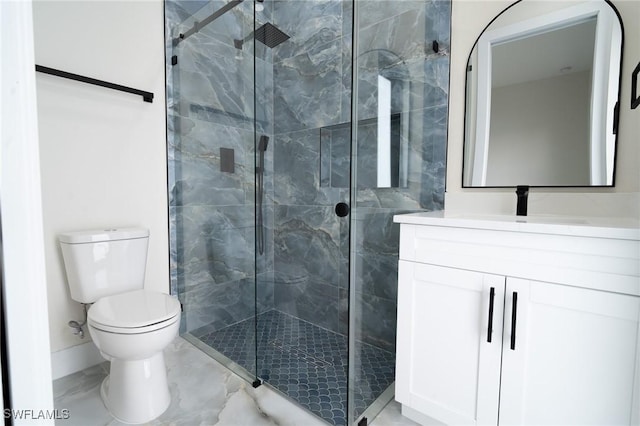 bathroom with a shower with door, vanity, and toilet