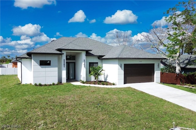 view of front of home with a garage and a front lawn