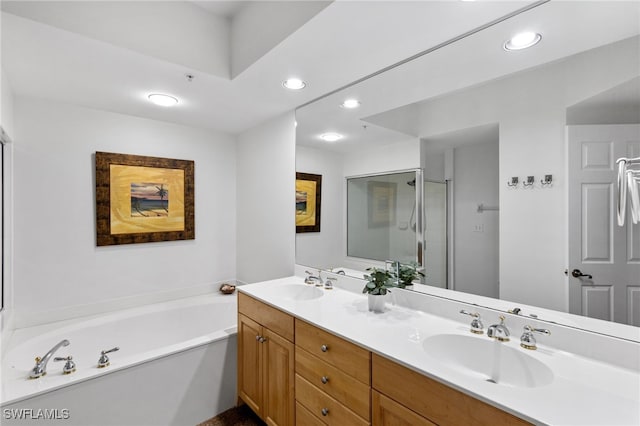 full bath with recessed lighting, a sink, a bath, and double vanity