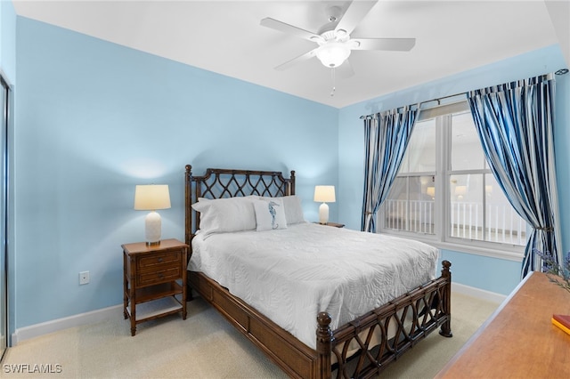 bedroom featuring light colored carpet, ceiling fan, and baseboards