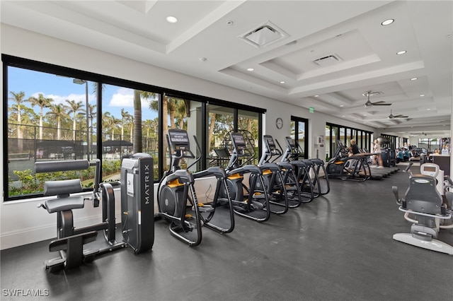 exercise room with recessed lighting, a raised ceiling, visible vents, and baseboards