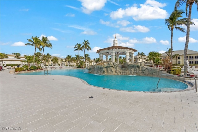 community pool with a gazebo and a patio