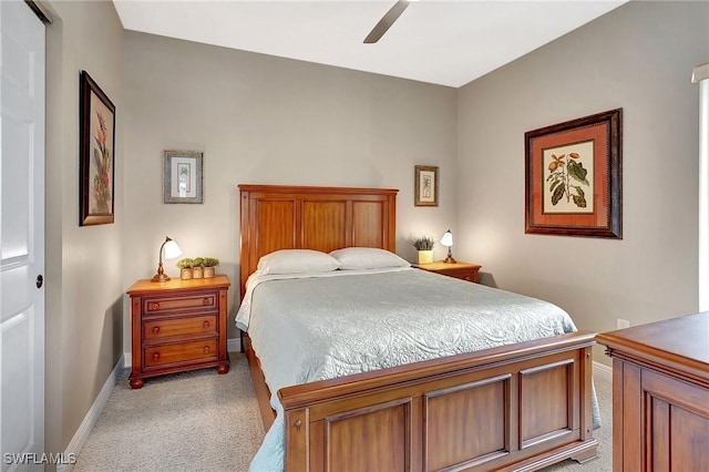 bedroom with ceiling fan and light carpet