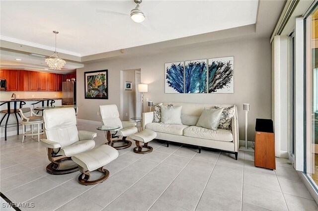 living room featuring light tile patterned floors, an inviting chandelier, and a raised ceiling