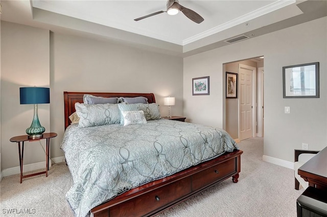 carpeted bedroom with ceiling fan and a raised ceiling