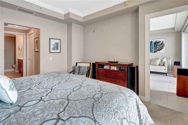carpeted bedroom featuring crown molding and connected bathroom