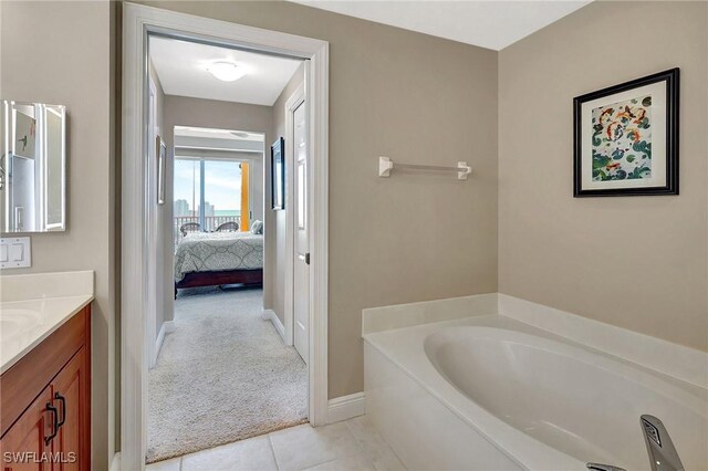 bathroom with vanity, a washtub, and tile patterned floors