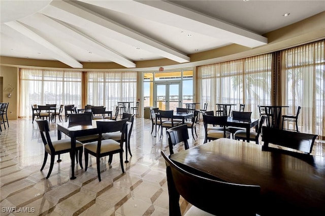 dining space featuring beamed ceiling and french doors