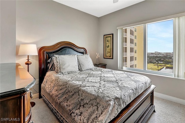 bedroom featuring light carpet